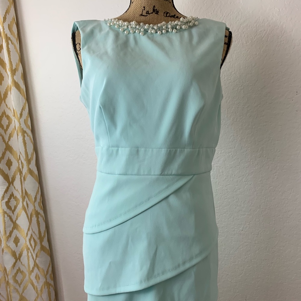 Turquoise dress with pearl beads around neck